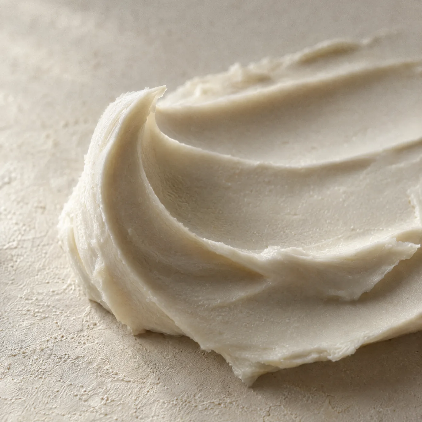 A thick ivory cream swept into soft peaks on cream plaster.